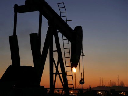 FILE - In this Jan. 18, 2016 file photo, an oil pump works at sunset, in the desert oil fi