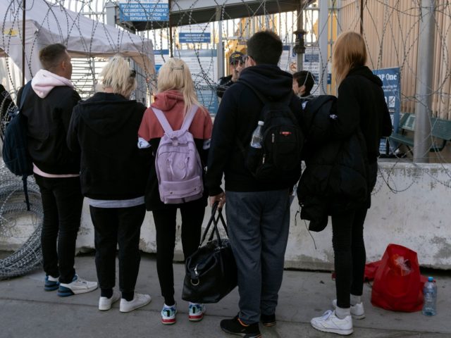 A group people from Ukraine talk to a CBP officer at San Ysidro Crossing port in Tijuana,