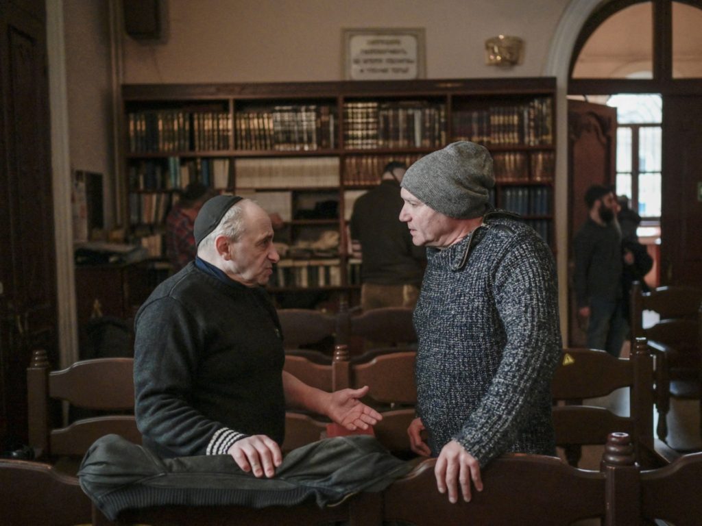 Members of Jewish community chat in the Chabad Synagogue in Odessa on March 9, 2022, 14 days after Russia launched a military invasion on Ukraine. - Forced yet again into exile, as so many times in their tormented history, Jews are leaving in droves from the Ukrainian city of Odessa, threatening the last traces of a once-vibrant culture. The Black Sea port, a place steeped in Jewish history, now sees many joining the throngs as they pack buses and trains heading for Moldova or Romania. Some will go on to Germany, the United States, or Israel. Many are old, knowing that they may well never return. (Photo by BULENT KILIC / AFP) (Photo by BULENT KILIC/AFP via Getty Images)