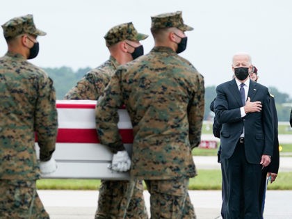 President Joe Biden, first lady Jill Biden and Secretary of Defense Lloyd Austin watch as a Marine Corps carry team moves a transfer case containing the remains of Marine Corps Lance Cpl. Dylan Merola, 20, of Rancho Cucamonga, Calif., Sunday, Aug. 29, 2021, at Dover Air Force Base, Del. Biden …