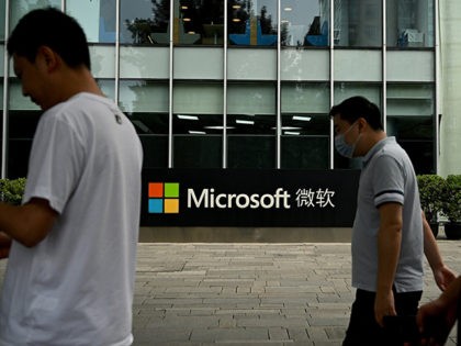 Pedestrians walk past Microsoft's local headquarters in Beijing on July 20, 2021, the day after the US accused Beijing of carrying out the cyber attack on Microsoft and charged four Chinese nationals over the "malicious" hack in March. (Photo by Noel Celis / AFP) (Photo by NOEL CELIS/AFP via Getty …