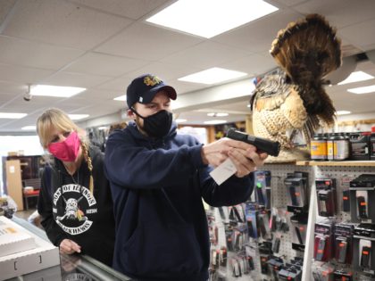 TINLEY PARK, ILLINOIS - APRIL 08: Alexander Carey (R), accompanied by his mother Rosalie, shops for a new handgun at Freddie Bear Sports on April 08, 2021 in Tinley Park, Illinois. President Joe Biden today announced gun control measures which included stricter controls on the purchase of homemade firearms, commonly …