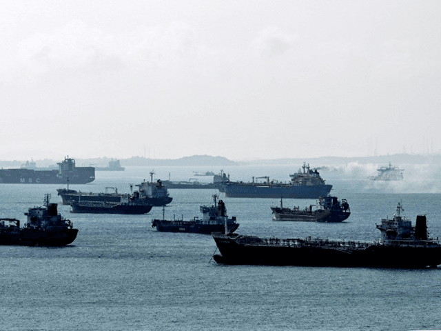Oil tankers are anchored off the western shores of Singapore, where tycoon O.K. Lim built