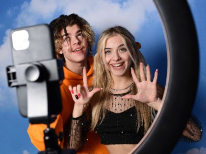 TikTok influencers Florin Vitan (L) and Alessia Lanza perform a video for the social network TikTok in the "Defhouse", a TikTok influencers incubator in Milan, on January 21, 2021. - With dreams of the big screen but Internet in their veins, eight young Italian influencers are racking up followers as …