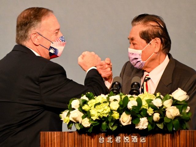 Former US secretary of state Mike Pompeo bumps fists with former Taiwan foreign minister Mark Chen before delivering his speech in Taipei on March 5, 2022. (Photo by SAM YEH/AFP via Getty Images)