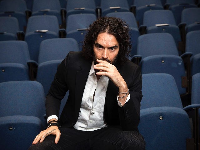 LONDON, ENGLAND - NOVEMBER 25: Russell Brand poses for photographs as he arrives to deliver The Reading Agency Lecture at The Institute of Education on November 25, 2014 in London, England. Russell Brand will deliver 'a manifesto on reading' which will be in part personal, sharing his own experience of …