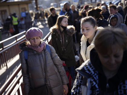 People wait in a line to board a train leaving for Lviv in Ukraine at the train station in Przemysl, Poland, Monday, March 14, 2022. While tens of thousands of people have fled Ukraine every day since Russia's invasion, a small but growing number are heading in the other direction. …