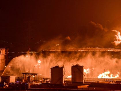 Water is sprayed by fire brigades toward the smoke and flames rising from a Saudi Aramco oil facility in Saudi Arabia's Red Sea coastal city of Jeddah, on March 25, 2022, following a reported Yemeni rebels attack. - Yemeni rebels said they attacked a Saudi Aramco oil facility in Jeddah …