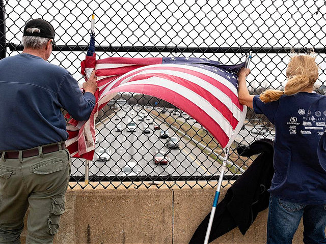 Supporters stand on an overpass in Lake Arbor, Maryland, on March 7, 2022, as demonstrator