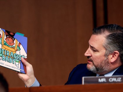 WASHINGTON, DC - MARCH 22: Sen. Ted Cruz (R-TX) holds up a book on antiracism as he questi