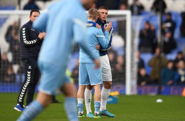 Everton's Ukrainian defender Vitaliy Mykolenko (R) embraced his compatriot Oleksandr Zinch