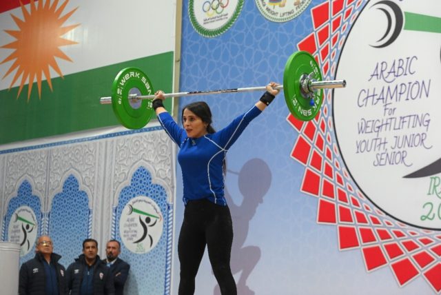 An Iraqi Kurdish woman competes during a weightlifting championship in Iraq's Kurdish regi
