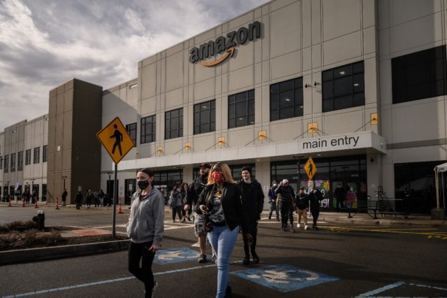 Workers walk to cast their votes over whether or not to unionize, outside an Amazon wareho