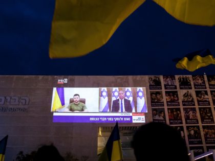 TEL AVIV, ISRAEL - MARCH 20: Demonstrators gather to watch Ukrainian President Volodymyr Zelensky's speech to the Israeli parliament as it broadcasted at Habima Square on March 20, 2022 in Tel Aviv, Israel. Ukrainian President Zelensky has been making a virtual world tour in recent weeks, lobbying foreign governments by …