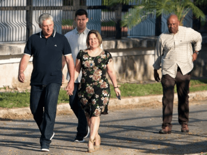 Cuba's President Miguel Diaz-Canel and his wife Lis Cuesta arrive at a polling station to cast their votes for a constitutional referendum in Havana, Cuba, on February 24, 2019. - Cubans vote on a new constitution for the first time in decades, a poll seen as a possible referendum on …