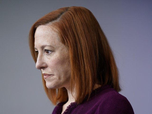 White House press secretary Jen Psaki listens to a reporter's qustion during a press brief