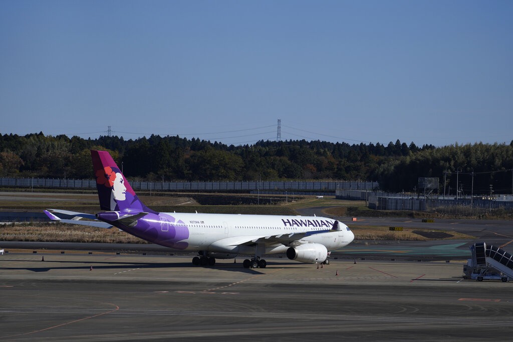 A Hawaiian Airlines plane at the Narita International Airport in Narita, east of Tokyo, Thursday, Dec. 2, 2021. (AP Photo/Hiro Komae)