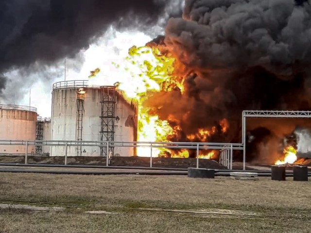 In this handout photo released by Russian Emergency Ministry Press Service on Friday, April 1, 2022, a view of the site of fire at an oil depot in Belgorod region, Russia. The governor of the Russian border region of Belgorod accused Ukraine of flying helicopter gunships into Russian territory and …