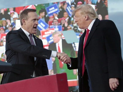 Republican candidate for U.S. Senate (N.C.) Ted Budd, left, shakes hands with former President Donald Trump, who endorsed him, during a rally Saturday, April 9, 2022, in Selma, N.C. (AP Photo/Chris Seward)