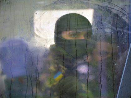 A volunteer of the Ukrainian Azov regiment looks through a bus window before a departure to the east of Ukraine after taking part in trainings at a base in Kiev on May 7, 2015. Ukrainian and separatist representatives met in Minsk on May 6, 2015 for the first time since …