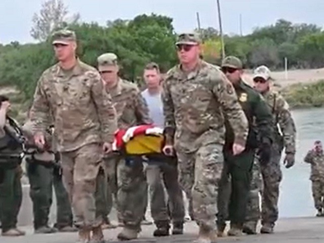 Texas National Guard Soldiers carry the flag-draped body of SPC Bishop Evans after he was found in the Rio Grande on Monday. (Fox News Video Screenshot)
