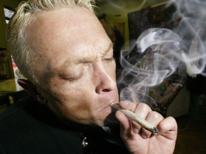 Jim Brydges, a medical marijuana exemptee who is living with HIV/AIDS, smokes marijuana June 2, 2003, at a Toronto Hemp Store. Brydges can legally poses up to 150 grams of the drug for medical purposes.