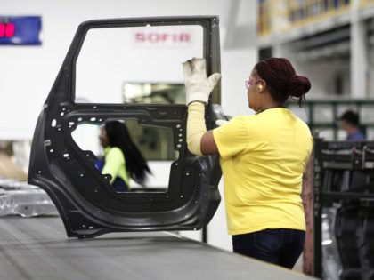 WARREN, MI - JANUARY 22: A worker handles a door that came out of the new $63 million press at the Fiat Chrysler Automobiles US Warren Stamping Plant January 22, 2016 in Warren, Michigan. FCA US officially dedicated the new press line featuring a $63 million high-speed press at the …