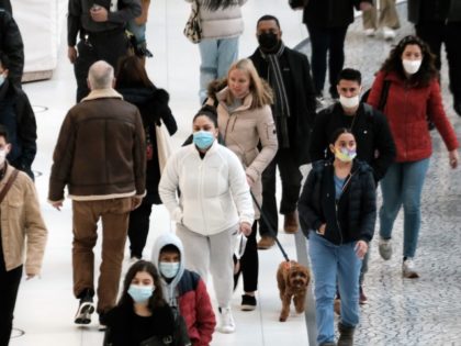 NEW YORK, NEW YORK - DECEMBER 13: People wear masks at an indoor mall in The Oculus in low