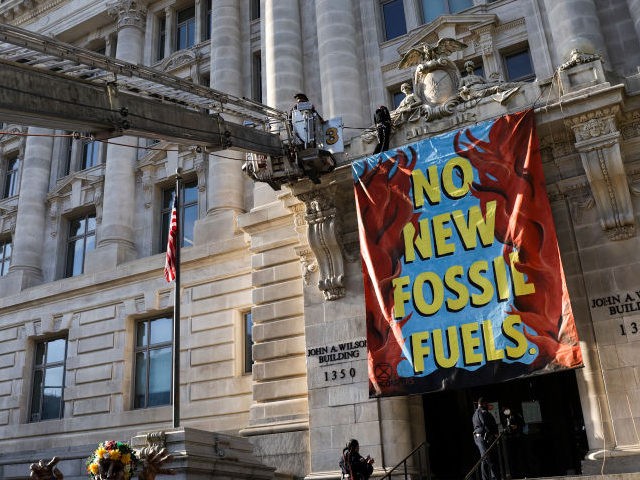 The fire department uses a ladder truck to remove an environmental activists with the group Extinction Rebellion DC after they scaled the Wilson Building as part of an Earth Day rally against fossil fuels on April 22, 2022 in Washington, DC. The group is protesting Washington Gas's use of methane …