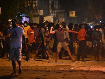 Demonstrators throw rocks during a clash with riot police as people demonstrate outside Sri Lanka's President Gotabaya Rajapaksa's home to call for his stepping down as the country's unprecedented economic crisis worsened in Colombo, on March 31, 2022. - The protest trying to storm the home of Sri Lankan President …