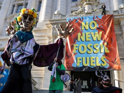 Environmental activists with the group Extinction Rebellion DC participate in an Earth Day rally against fossil fuels at the Wilson Building on April 22, 2022 in Washington, DC. The group is protesting Washington Gas's use of methane and their planned expansion of gas infrastructure. (Photo by Kevin Dietsch/Getty Images)