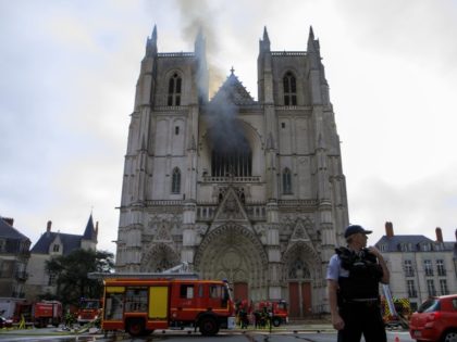 Fire fighters brigade work to extinguish the blaze at the Gothic St. Peter and St. Paul Cathedral, in Nantes, western France, Saturday, July 18, 2020. The fire broke, shattering stained glass windows and sending black smoke spewing from between its two towers of the 15th century, which also suffered a …