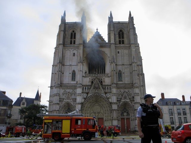 Fire fighters brigade work to extinguish the blaze at the Gothic St. Peter and St. Paul Ca