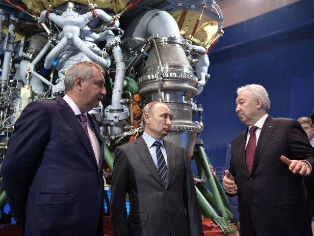 Russian President Vladimir Putin (C) and the State space corporation Roscosmos head Dmitry Rogozin (L) listen to Director of Russian rocket engine manufacturer NPO Energomash Igor Arbuzov in Khimki, outside Moscow on April 12, 2019. (Photo by ALEXEY NIKOLSKY/SPUTNIK/AFP via Getty Images)