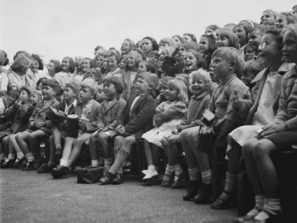 A young audience watches the topical wartime Punch and Judy puppet show of ' professor ' T