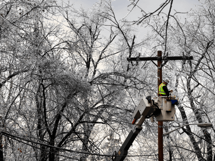 A worker repairs power lines as winter storm brings havoc to New Jersey as ice caused powe