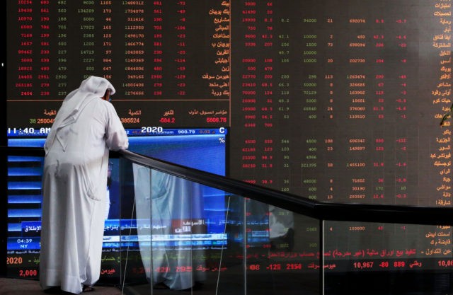 TOPSHOT - A Kuwaiti trader checks stock prices at Boursa Kuwait in Kuwait City, on March 8