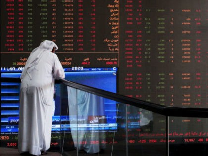 TOPSHOT - A Kuwaiti trader checks stock prices at Boursa Kuwait in Kuwait City, on March 8