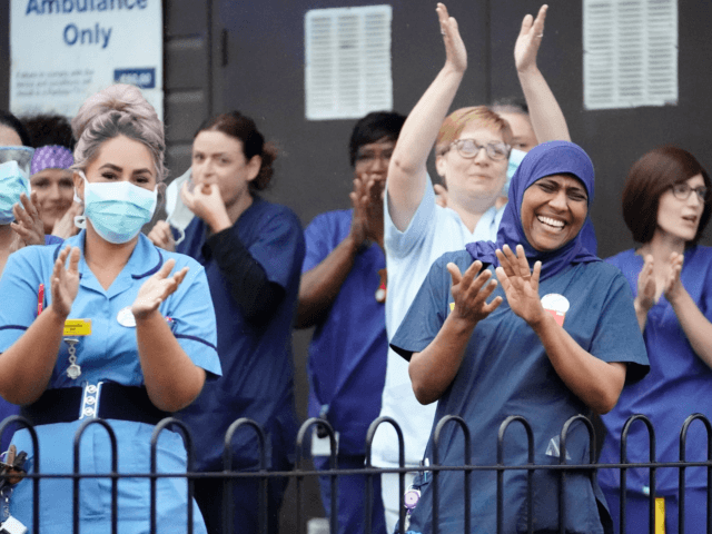 WALSALL, ENGLAND - APRIL 30: NHS staff applaud themselves and their colleagues at the entr