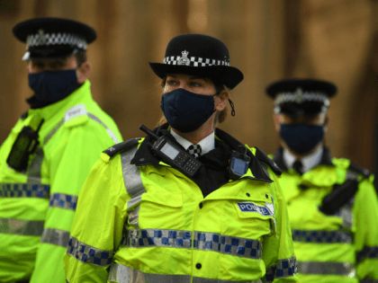 Police officers wearing protective face coverings to combat the spread of the coronavirus covid-19 oversee an anti-vax rally protest against vaccination and government restrictions designed to control or mitigate the spread of the novel coronavirus, including the wearing of masks and lockdowns, in Liverpool on November 14, 2020. (Photo by …