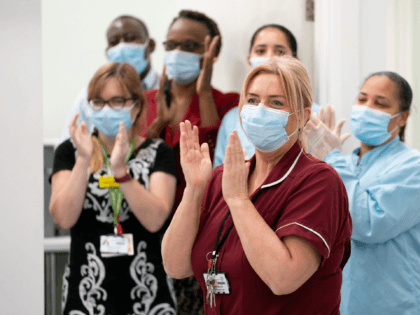 LONDON, ENGLAND - DECEMBER 08: Doctors and nurses clap after general manager of Covid Reco