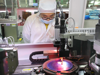 An employee makes chips at a factory of Jiejie Semiconductor Company in Nantong, in easter