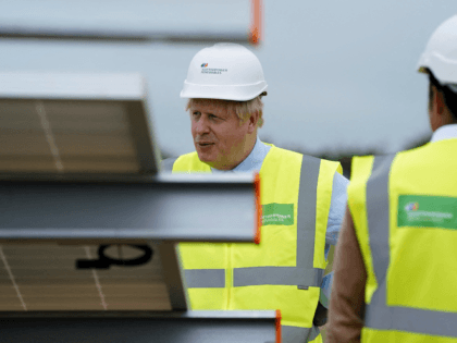 Britain's Prime Minister Boris Johnson (L) gestures during a visit to the Scottish Power Carland Cross Windfarm in Newquay, Cornwall on June 9, 2021, where he viewed new construction on a solar farm. (Photo by Jon Super / POOL / AFP) (Photo by JON SUPER/POOL/AFP via Getty Images)