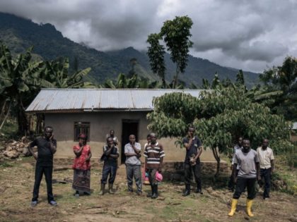 Survivors of the attack on the village of Mwenda pose for a photograph, in Rwenzori Sector, northeastern Democratic Republic of Congo, on May 23, 2021. - Since December 2020, several dozen deadly attacks have taken place at the foot of the Rwenzori Mountains and in surrounding villages. Since October 2019 …