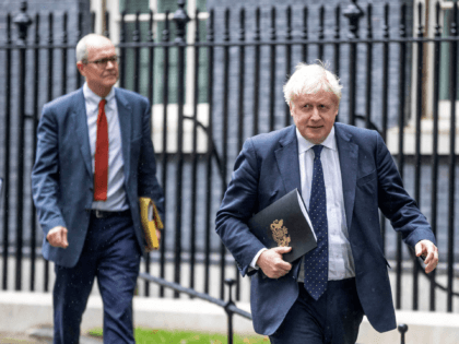 Britain's Prime Minister Boris Johnson (R), Britain's Chief Medical Officer for England Chris Whitty (L) and Britain's Chief Scientific Adviser Patrick Vallance leave 10 Downing Street to attend a media briefing on the latest Covid-19 update, at Downing Street, central London on September 14, 2021. - Frontline health and social …