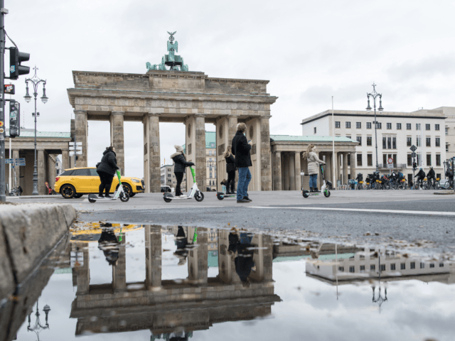 BERLIN, GERMANY - NOVEMBER 08: People walk past the Brandenburger Gate on November 8, 2021