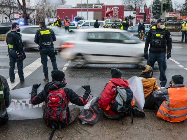 BERLIN, GERMANY - JANUARY 24: Police officers stand on patrol as activists block the end of a highway to protest against food waste on January 24, 2022 near Berlin, Germany. The activists are from the group "Letzte Generation" (Last Generation) and are demanding change to a law in Germany that …