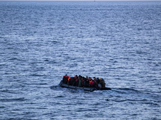 Migrants sits in a dinghy illegally crossing the English Channel from France to Britain on