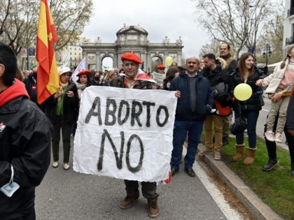 A demonstrator wearing a Carlist red beret holds a banner against abortion during the anti-abortion march "Si a la vida" (Yes to life) on March 27, 2022 in Madrid. - Hundreds of people marched trhough central Madrid to protest against abortion as the Spanish government prepares a law to guarantee …