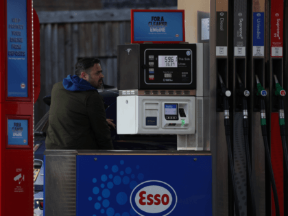 LONDON, ENGLAND - MARCH 31: A man refuels his car at an Esso petrol station on March 31, 2022 in London, England. Energy and fuel bills are rising in the UK due to a combination of factors. Russia's war on Ukraine has increased global oil prices which affects increases at …